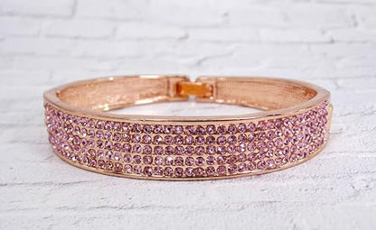 Pink crystal bangle bracelet with sparkling crystals expandable open hinge in a rose gold finish. Women's fashion dressy formal wedding bracelet