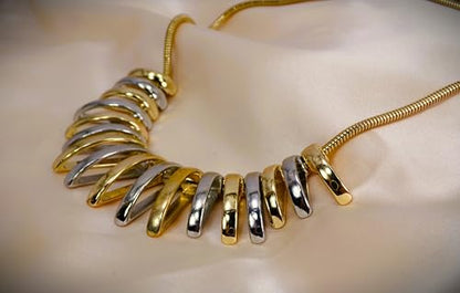 Silver and gold necklace designed with dome shape metal links attached to a snake chain. Two tone fashion necklace.