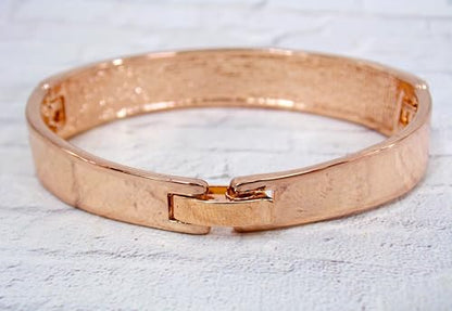 Pink crystal bangle bracelet with sparkling crystals expandable open hinge in a rose gold finish. Women's fashion dressy formal wedding bracelet