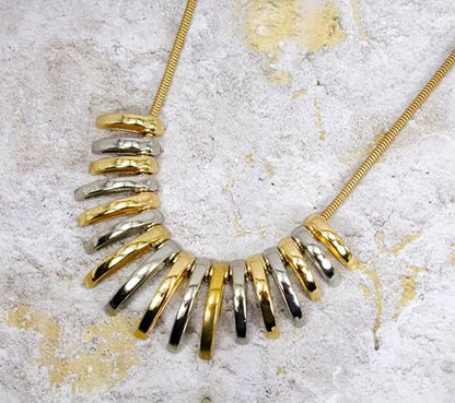 Silver and gold necklace designed with dome shape metal links attached to a snake chain. Two tone fashion necklace.