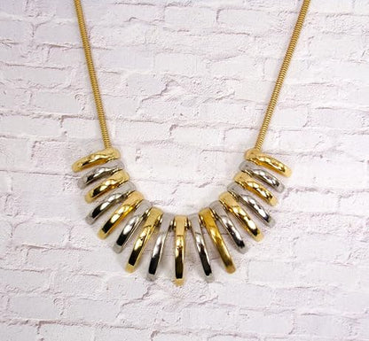 Silver and gold necklace designed with dome shape metal links attached to a snake chain. Two tone fashion necklace.