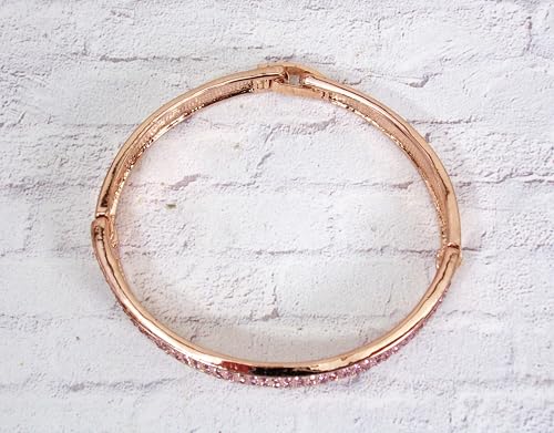 Pink crystal bangle bracelet with sparkling crystals expandable open hinge in a rose gold finish. Women's fashion dressy formal wedding bracelet