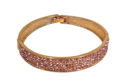 Pink crystal bangle bracelet with sparkling crystals expandable open hinge in a rose gold finish. Women's fashion dressy formal wedding bracelet