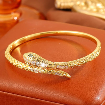 Gold Snake Bangle Bracelet for Women, Cubic Zirconia Copper Cuff Jewelry | Gold-plated copper snake cuff with cubic zirconia, green stone accent and comfortable open cuff design.